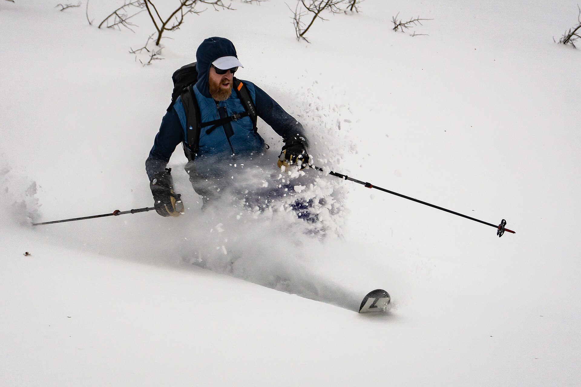 A backcountry skier throws up a plume of deep powder on Rodeo Ridge in the mountains east of Ogden, Utah