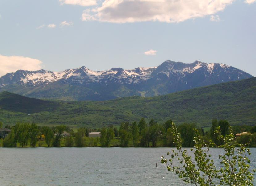 Mount Ogden rising beyond the blue water of Pineview Reservoir in Ogden Valley